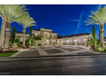 Luxury home with palm trees and a large driveway at 52 Innisbrook Ave, Las Vegas, NV 89113