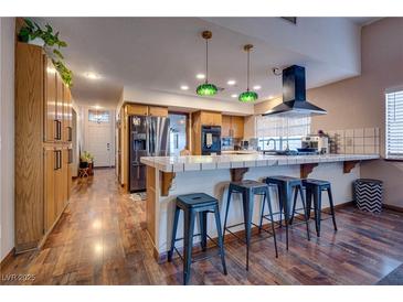 Bright kitchen with stainless steel appliances and breakfast bar at 5242 Dickens Dr, Las Vegas, NV 89119