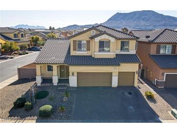 Two-story house with a landscaped yard and two-car garage at 633 Finch Island Ave, Henderson, NV 89015