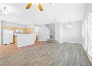 Open concept kitchen and dining area with tile and wood floors at 6637 Lookout Lodge Ln # 2, North Las Vegas, NV 89084