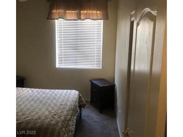 Cozy bedroom with nightstands and window coverings at 9016 Gabro Ln, Las Vegas, NV 89123