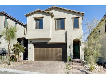 Charming two-story home with brown two-car garage and landscaped front yard at 11560 Observation Point Ave, Las Vegas, NV 89138