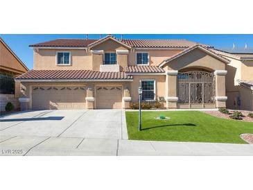 Two-story house with a three-car garage and landscaped lawn at 1559 Via Della Scala, Henderson, NV 89052