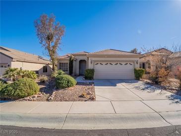 Single-story house with attached garage and well-manicured landscaping at 1803 Eagle Village Ave, Henderson, NV 89012