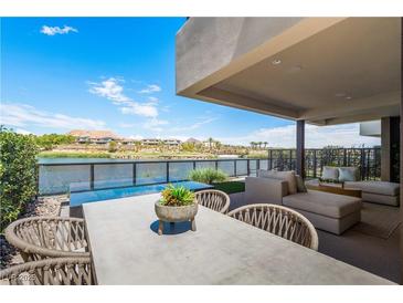 Covered patio with lake view, seating area, and dining table at 20 Lakefront Dr, Henderson, NV 89011