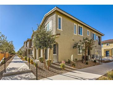 Tan two-story townhome with walkway and landscaping at 20 Barbara Ln # 35, Las Vegas, NV 89183