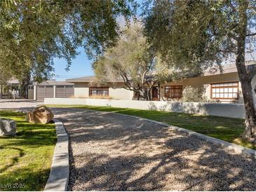 Luxury home with long driveway, mature trees, and attached garage at 2800 Ashby Ave, Las Vegas, NV 89102