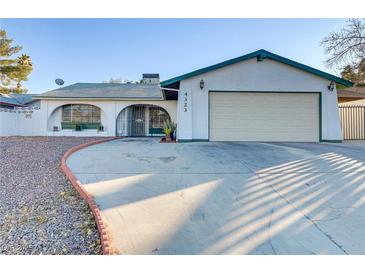 Single story home with attached garage and driveway at 4323 E Twain Ave, Las Vegas, NV 89121