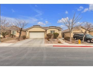 Single-story house with a two-car garage and landscaped front yard at 6054 Sierra Medina Ave, Las Vegas, NV 89139