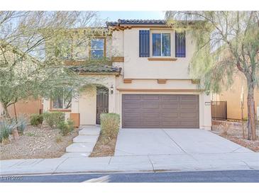 Two story house with brown garage door and neutral color exterior at 7659 Dewy Falls Ave, Las Vegas, NV 89179