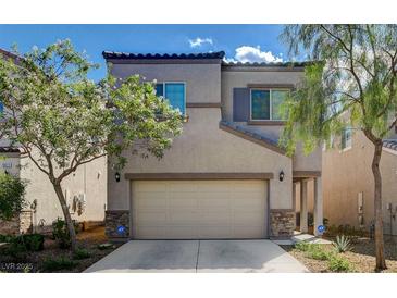 Two-story house with tan siding, stone accents, and a two-car garage at 9417 Sand Tiger Ave, Las Vegas, NV 89148