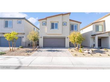 Two-story house with gray garage door and landscaped yard at 10009 Cabernet Hills St, Las Vegas, NV 89141