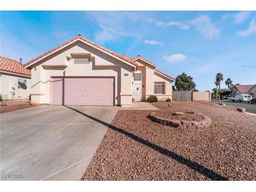 Single-story house with pink garage door and landscaped yard at 1064 Wide Brim Ct, Henderson, NV 89011