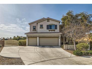 Two-story house with three-car garage and landscaped yard at 1738 Sonoran Bluff Ave, Henderson, NV 89014