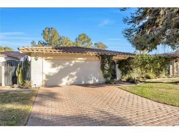 Spanish style home with brick driveway and mature landscaping at 1901 Calle De Espana, Las Vegas, NV 89102