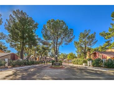 The Village Green community entrance with lush landscaping and gated access at 2360 Pickwick Dr, Henderson, NV 89014