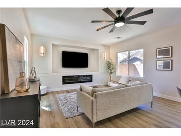 Spacious living room with fireplace and hardwood floors at 2892 Rothesay Ave, Henderson, NV 89044