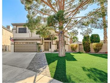 Two-story house with a landscaped yard, large tree, and a two-car garage at 3655 Funston Way, Las Vegas, NV 89129