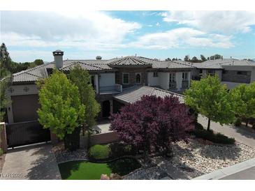 Stunning single-Gathering home with a well-manicured yard and mature trees under a bright sky at 4450 Palisades Canyon Cir, Las Vegas, NV 89129