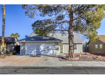 House exterior featuring a two-car garage and landscaping at 6008 Carmel Way, Las Vegas, NV 89108