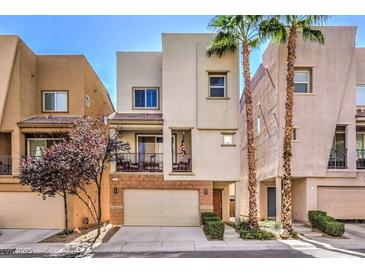 Two-story modern home with attached garage and balcony at 9361 Hilgard Ave, Las Vegas, NV 89178