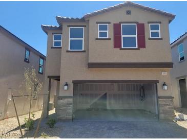 Inviting two-story home with red shutters, a two-car garage, and desert landscaping at 10039 Sir Atlas Ct, Las Vegas, NV 89148