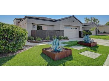 Single-story home with landscaped yard and modern facade at 10509 India Hawthorn Ave, Las Vegas, NV 89144