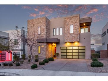 Stunning modern home with stone accents and a glass garage door at 220 Glen Lee St, Henderson, NV 89012