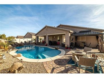 A beautiful outdoor pool and patio area perfect for entertaining or relaxing at 2540 E Sparrow Way, Pahrump, NV 89048