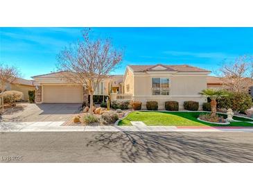 Single-story home with attractive landscaping and a two-car garage at 2589 Sumter St, Henderson, NV 89052