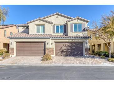 Two-story house with brown double garage and landscaped front yard at 3844 Juanita May Ave, North Las Vegas, NV 89032