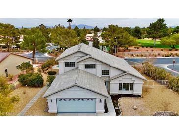 Two-story house with a gray roof, two-car garage, and landscaped yard at 5236 Woodlawn Ln, Las Vegas, NV 89130