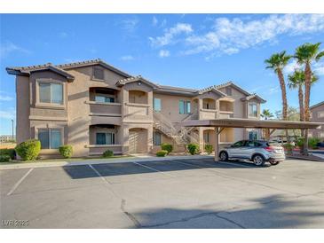 Tan two-story building with parking and palm trees at 8805 Jeffreys St # 1032, Las Vegas, NV 89123