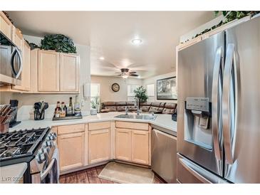 Modern kitchen with stainless steel appliances and light wood cabinets at 9103 Mcginnis Ave, Las Vegas, NV 89148