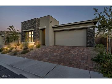 Single-story home with stone accents and a two-car garage at 928 Calluna Hills Ln, Las Vegas, NV 89138