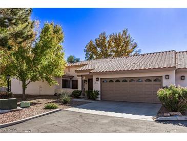 Attractive stucco home with a two-car garage and landscaped yard at 1911 Hobson Dr, Henderson, NV 89074