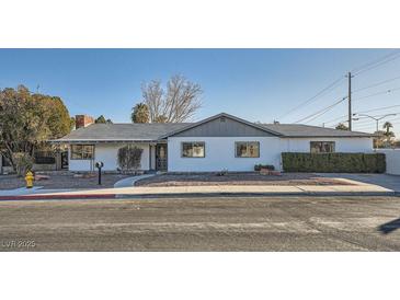 Ranch style home with a gray roof, white exterior, and well-manicured landscaping at 200 Rancho Vista Dr, Las Vegas, NV 89106