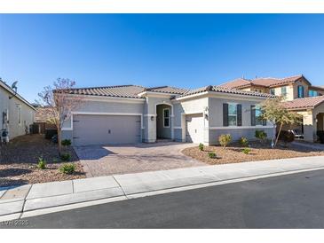 Single-story home with gray exterior, two-car garage, and landscaped front yard at 2469 Cingoli St, Henderson, NV 89044