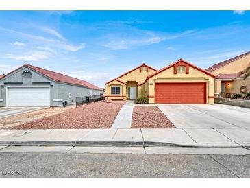 House exterior with orange garage door and rock landscaping at 3434 Empress Diamond Dr, North Las Vegas, NV 89032