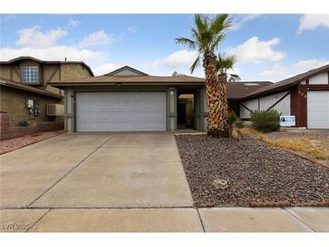 Single story house with attached garage and desert landscaping at 504 Crony Ave, Henderson, NV 89011