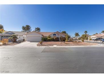 Single-story house with a landscaped yard and a two-car garage at 5305 Singing Hills Dr, Las Vegas, NV 89130