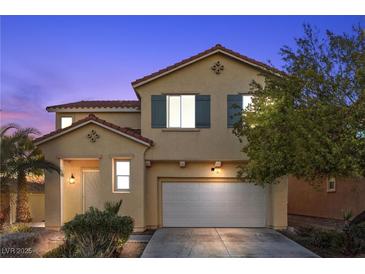 Two-story house with a white garage door and landscaping at 5445 Tallulah Falls St, North Las Vegas, NV 89081