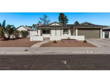 Ranch-style home with landscaped yard, attached garage, and walkway at 6412 Miragrande Dr, Las Vegas, NV 89108