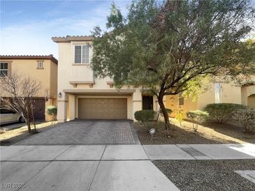 Two-story house with brown brick facade and paved driveway at 8465 Bellery Ave, Las Vegas, NV 89143