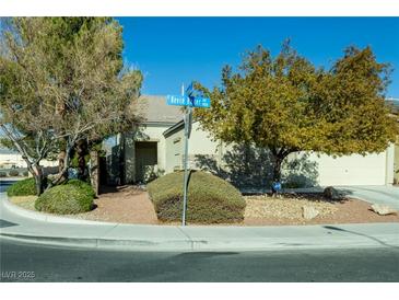 House exterior featuring a landscaped yard and two-car garage at 904 Kevin Baker Ave, North Las Vegas, NV 89086