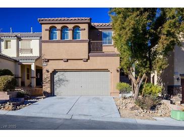 Two-story house with attached garage and landscaping at 9328 Black Wolf Ave, Las Vegas, NV 89178