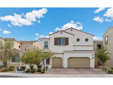 Charming two-story home with a well-maintained front yard and a two-car garage, all under a bright, partly cloudy sky at 9625 Ponderosa Skye Ct, Las Vegas, NV 89166