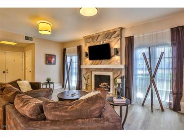Spacious living room featuring a cozy fireplace and ample natural light at 1409 E St Louis Ave # A, Las Vegas, NV 89104