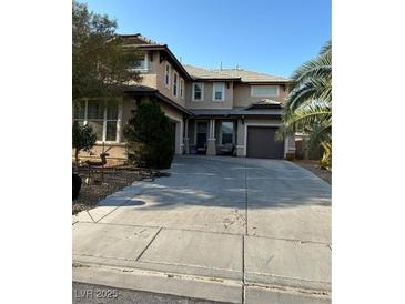 Two-story house with attached garage and landscaping at 2621 Slide Canyon Ave, North Las Vegas, NV 89081