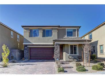 Two-story house with stone accents and a two-car garage at 319 Cooper Hawk Ct, Las Vegas, NV 89138